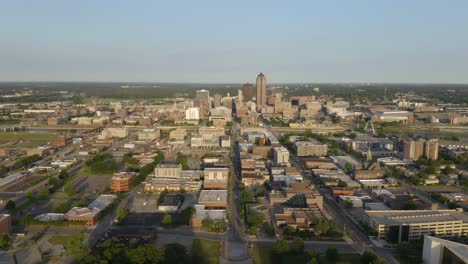 drone flies away from downtown des moines, iowa on summer morning