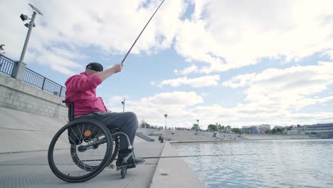 person with a physical disability who uses wheelchair fishing from fishing pier