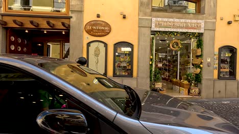 people and vehicles passing by shops