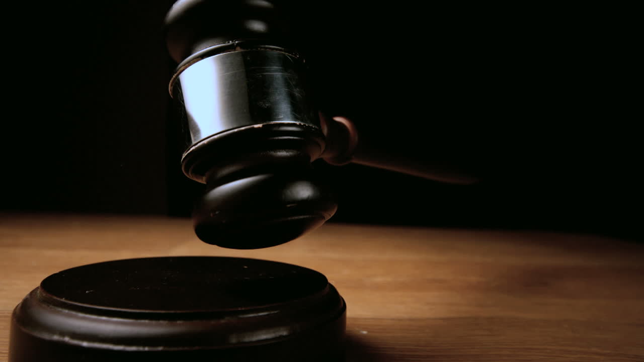 Mallet falling onto sounding block on wooden table