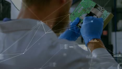 animation of network of connections over caucasian man repairing computer hardware