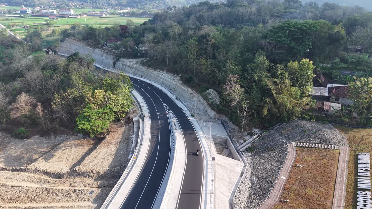 Aerial view, the new road that cuts through the hills from the city of Jogja to Gunungkidul passing the Banyunibo cliff climb