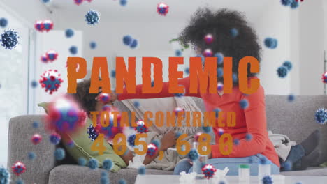 animation of virus cells and pandemic text over african american mother with sick son
