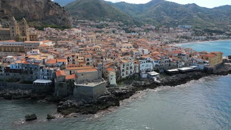 1-Aerial-footage-of-Cefalù-the-coastal-city-in-Sicily,-Southern-Italy