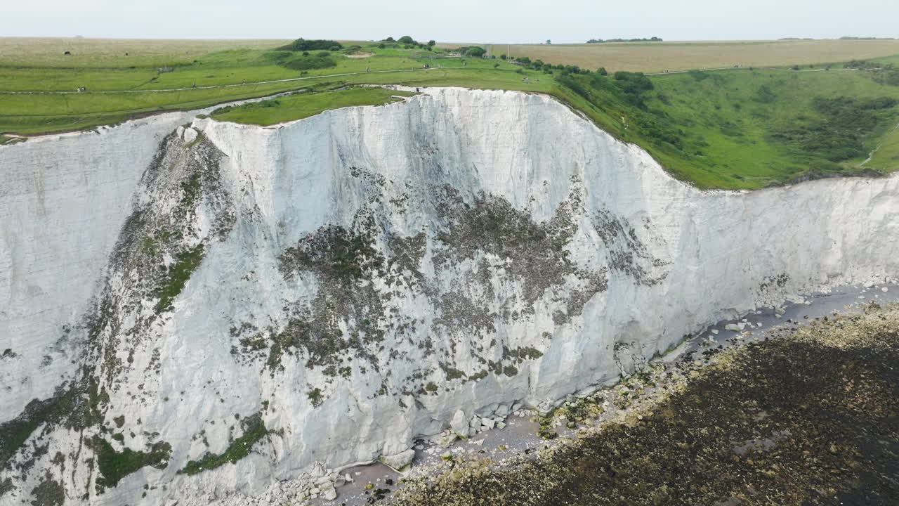 Reveals White Chalk Face Of The Cliffs Of Dover In England, United Kingdom. Aerial Tilt-up Shot