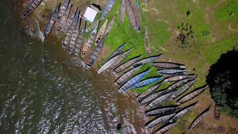 aerial drone shot of illegal fishing boats confiscated by police on the shores of lake victoria, tanzania