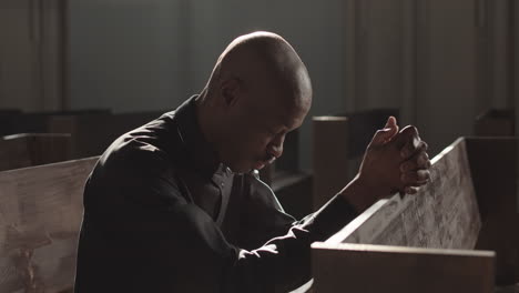 priest sitting in lutheran church and praying