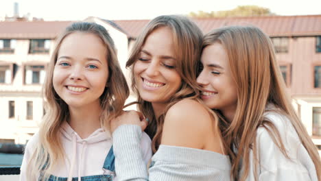 three happy friends posing outdoors