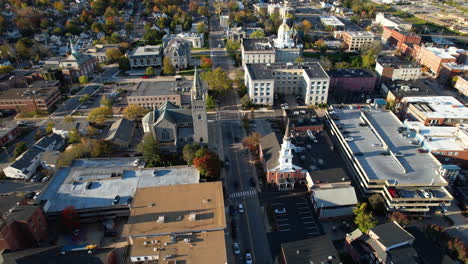 aerial view of downtown concord, new hampshire state capital, central buildings, streets and neighborhood on sunny autumn day, drone shot