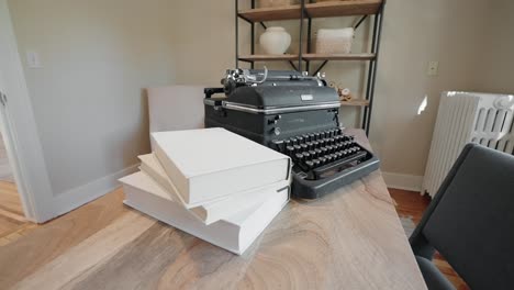 old typewriter and books on a wooden desk in the office of a home