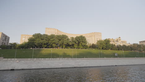 cityscape view of moscow river with a park and buildings