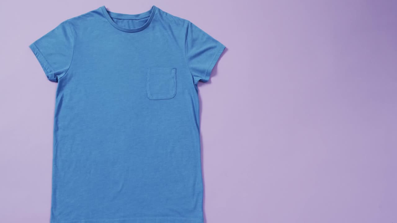 video de camiseta azul con etiqueta y espacio de copia en fondo púrpura