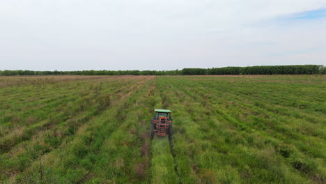 aerial view of tractor applying fertilizer on agricultural land, rural development