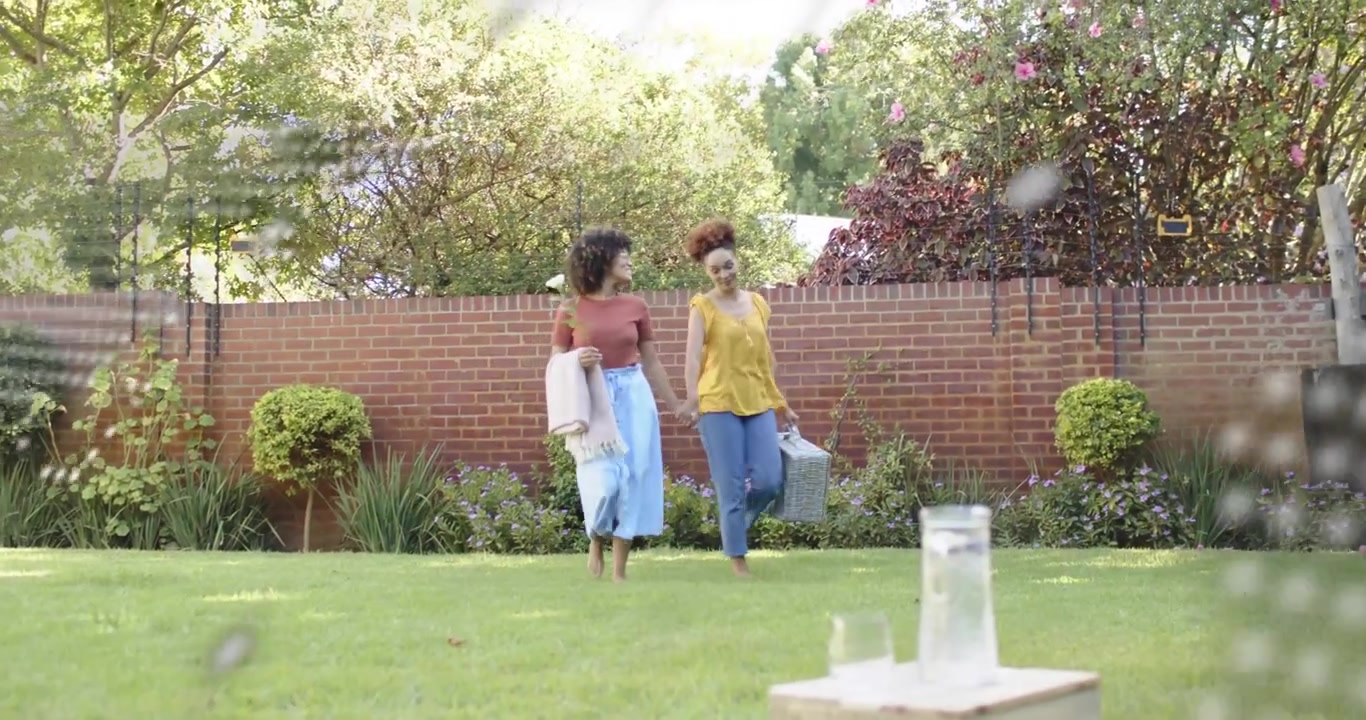 Friends walking with picnic basket in lifestyle activating text map overlay fading unpacking