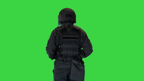 riot policeman in a helmet jogging on a green screen, chroma key