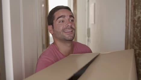 happy man coming into new house or apartment for the first time