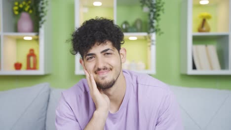 Romantic-young-man-making-heart-at-camera.