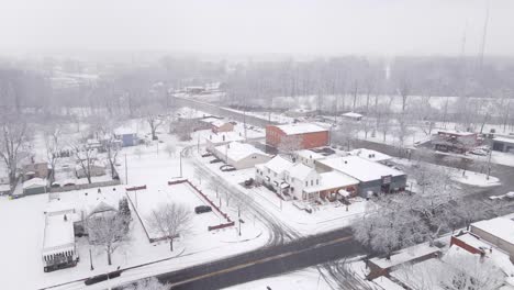 cozy carlton township in michigan during blizzard, aerial view