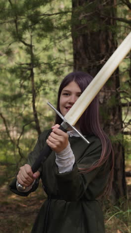 happy teenage girl in medieval clothes fights on swords in forest closeup slow motion. unusual sports hobby. training of middle aged ladies