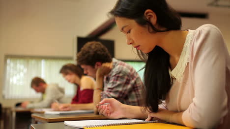 attentive students sitting an exam in a classroom