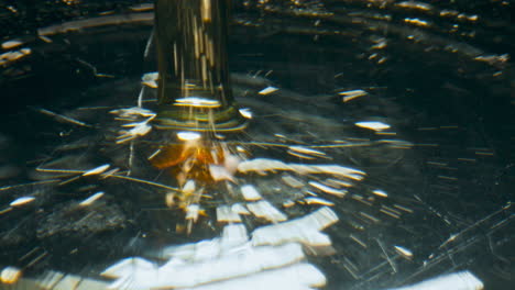 golden beverage splashing goblet closeup. pouring alcoholic sparkling liquid