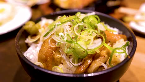 close up japanese style pork neck with ginger and scallion rice in traditional japanese restaurant, beautiful foods cultures