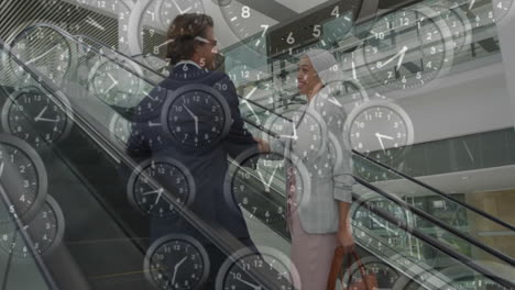 clocks animation over business people shaking hands on escalator in office building