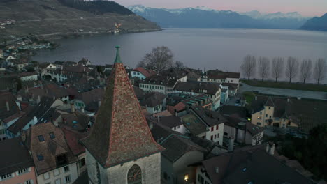 Jib-up-of-church-tower-overlooking-small-town-near-lake