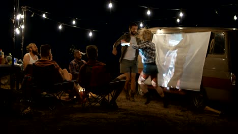 playful laughing people relaxing in campsite