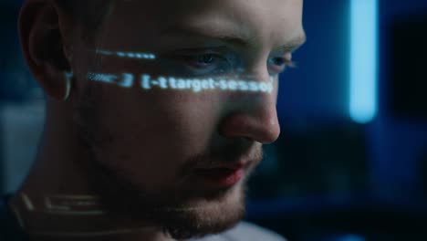 portrait of handsome software developer working on computer in digital identity cyber security data center, projected program coding language reflects on his face. futuristic hacking and programming