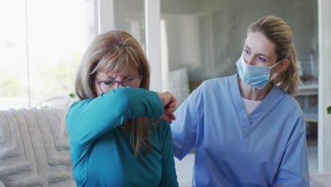 Senior-woman-coughing-on-her-elbow-at-home