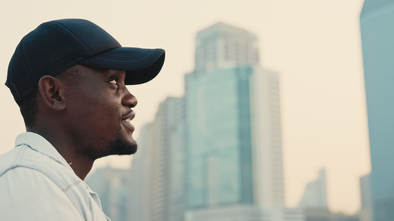 Man in profile view looking at cityscape
