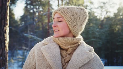 woman enjoying a winter day in the forest