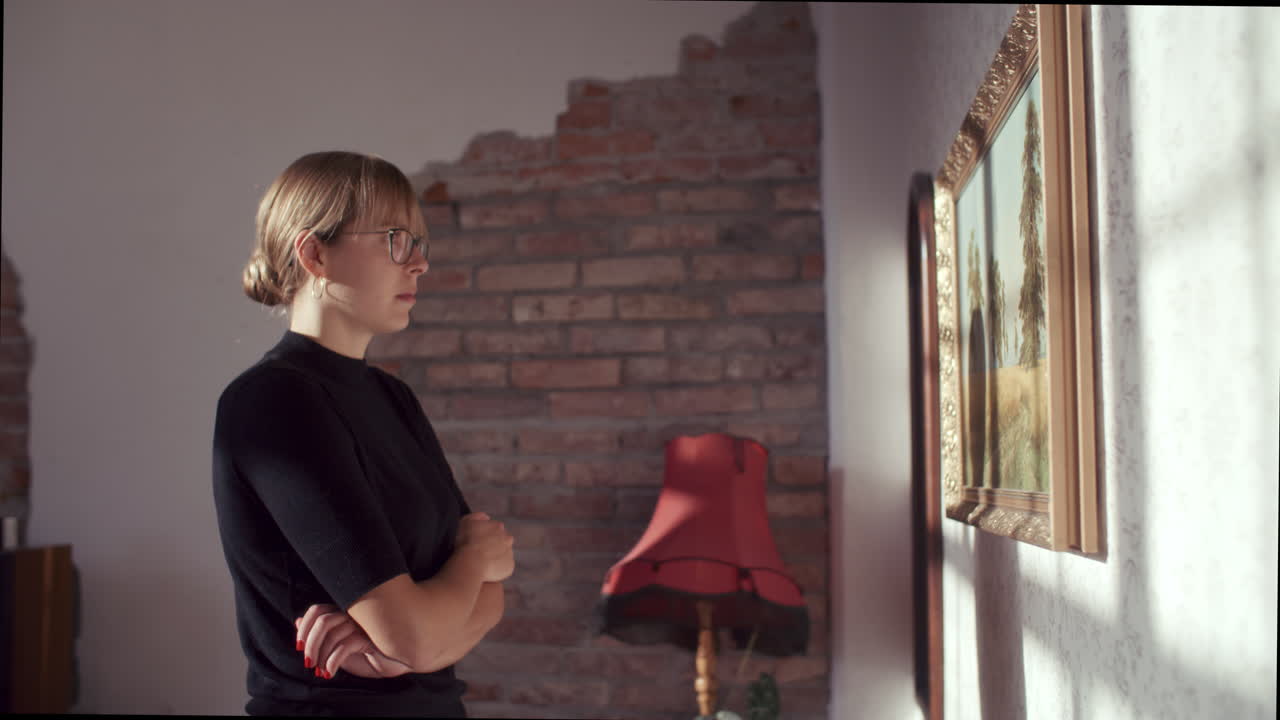 Woman Viewing a Painting in a Cozy Living Room
