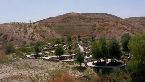 Low-panning-aerial-shot-of-a-serene-nature-garden-at-a-mortuary-in-California