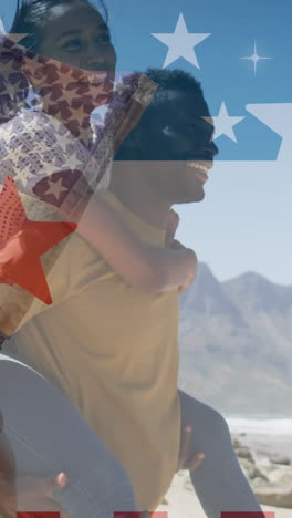 animación de la bandera estadounidense sobre una pareja diversa sonriente llevando en las montañas