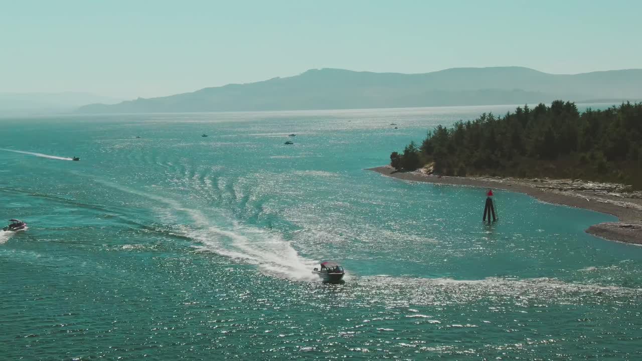 4k Aerial Boat approaching with mountains and little island in background