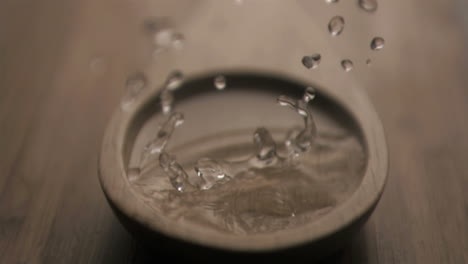 drop in super slow motion falling in a wooden spoon