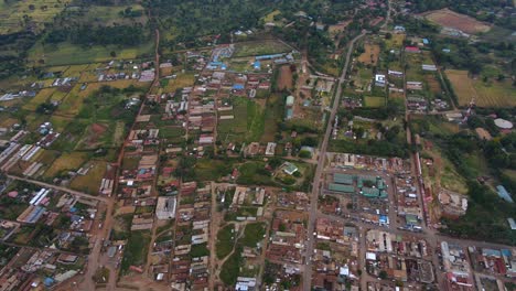 Aerial-view-overlooking-the-Loitokitok-village-in-Amboseli,-Kenya---high-angle,-reverse,-drone-shot