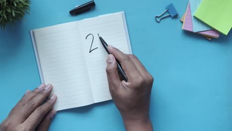 person writing in a notebook