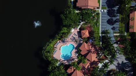 aerial view of luxury apartment complex with pool and lake
