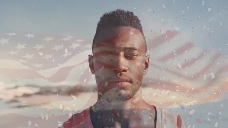 Animation of flag of united states of america and confetti over african american man on beach