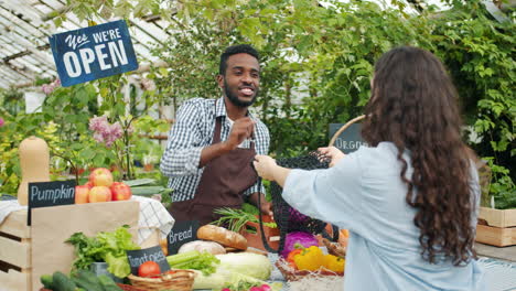 farmer's market transaction in a greenhouse