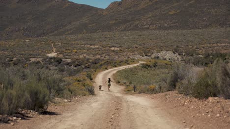 woman is running with her dog in the wilderness of nature