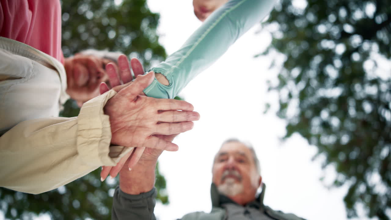Group of seniors putting hands together