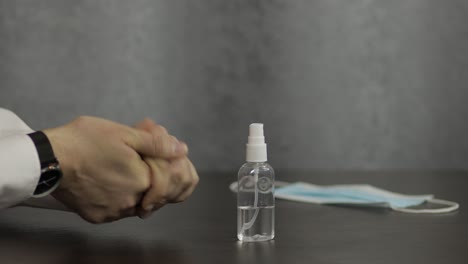 man using bottle of liquid alcohol spray sanitizer with hands. coronavirus