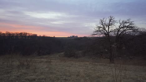 sunset in rural wisconsin with farm in the distance.