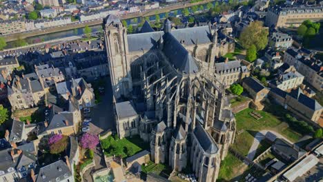 receding top-down perspective movement from the iconic cathedral of saint julian of le mans with market des jacobins, le mans, france.