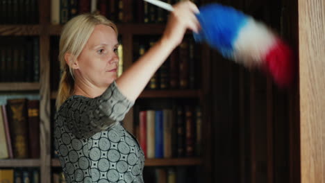 Woman-Cleaning-Bookshelves