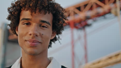 smiling teenager posing sunset street portrait. curly hair model looking camera